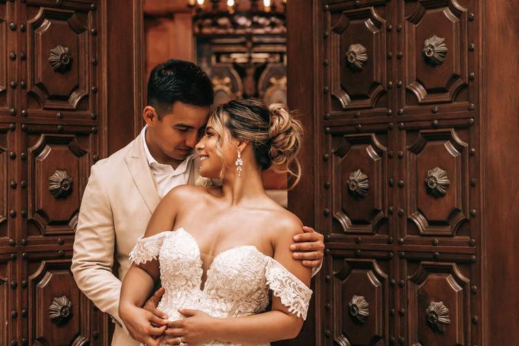 Wedding couple at ornate carved doors Cabo San Lucas — Ana Badillo Photography