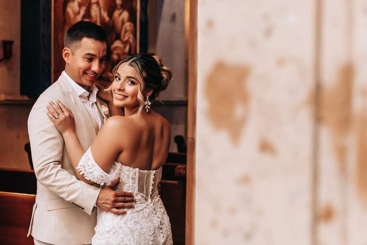 Couple smiling in church doorway Cabo — Ana Badillo Photography