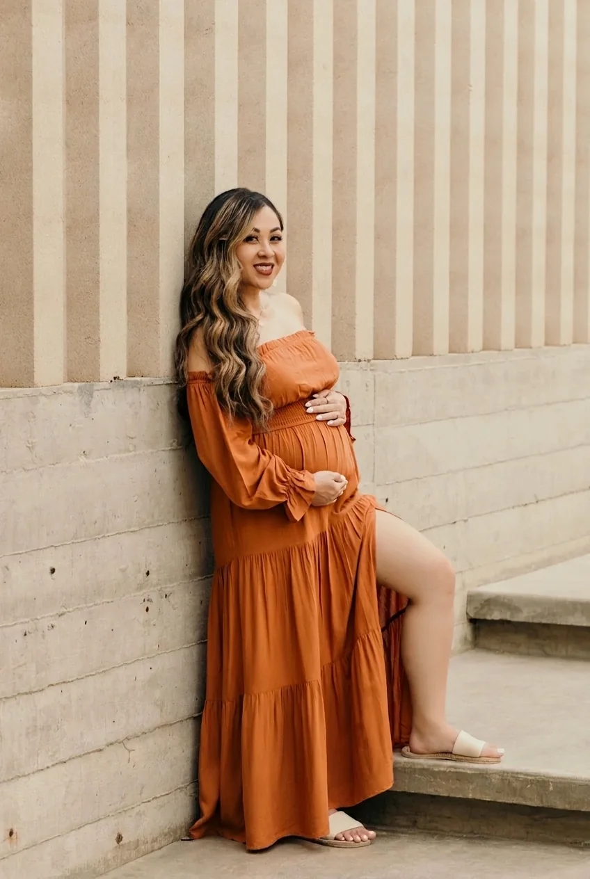 Editorial maternity portrait on textured concrete steps at Acre Resort